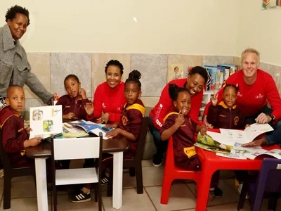 Emperors Palace staff and executives with learners at Cute Kiddies Day Centre