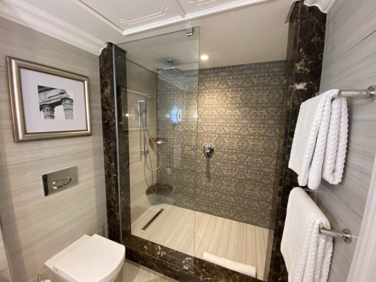 Deluxe room bathroom with walk-in glass shower at the D'oreale Grande