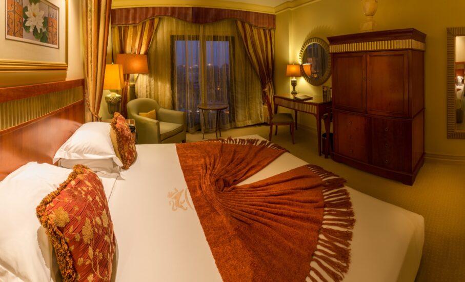 Classic King room with writing desk and wooden armoire at the D'oreale Grande