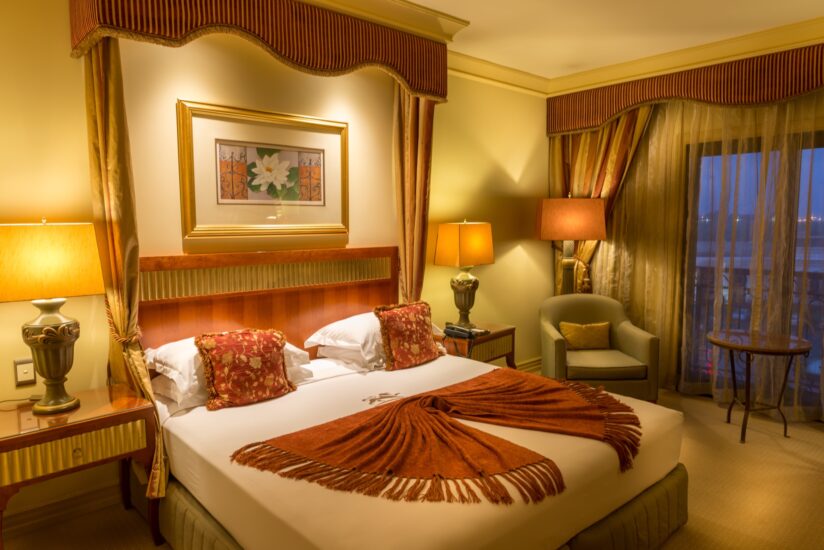 Classic King room with draped four-poster bed at the D'oreale Grande, Emperors Palace