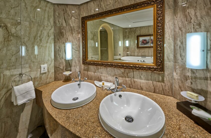 Executive Suite bathroom with twin basins and gilt mirror at the D'oreale Grande
