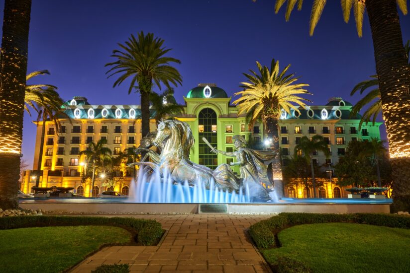 Illuminated horse fountain and facade at twilight, D'oreale Grande, Emperors Palace