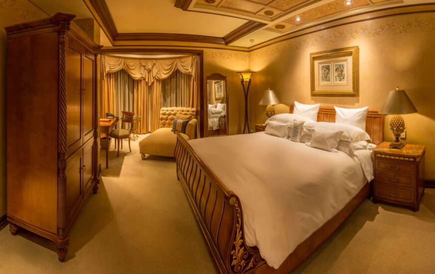 Junior Suite bedroom with armoire and desk at the D'oreale Grande