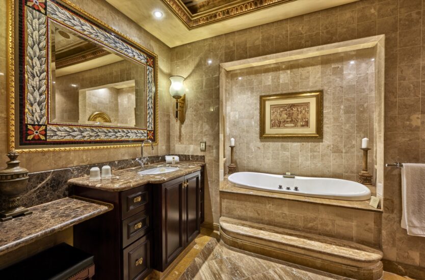 Presidential Suite bathroom with tub, ornate mirror and vanity at the D'oreale Grande