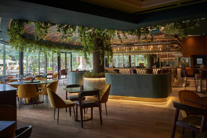 Restaurant bar with hanging greenery and velvet seating at the D'oreale Grande, Emperors Palace
