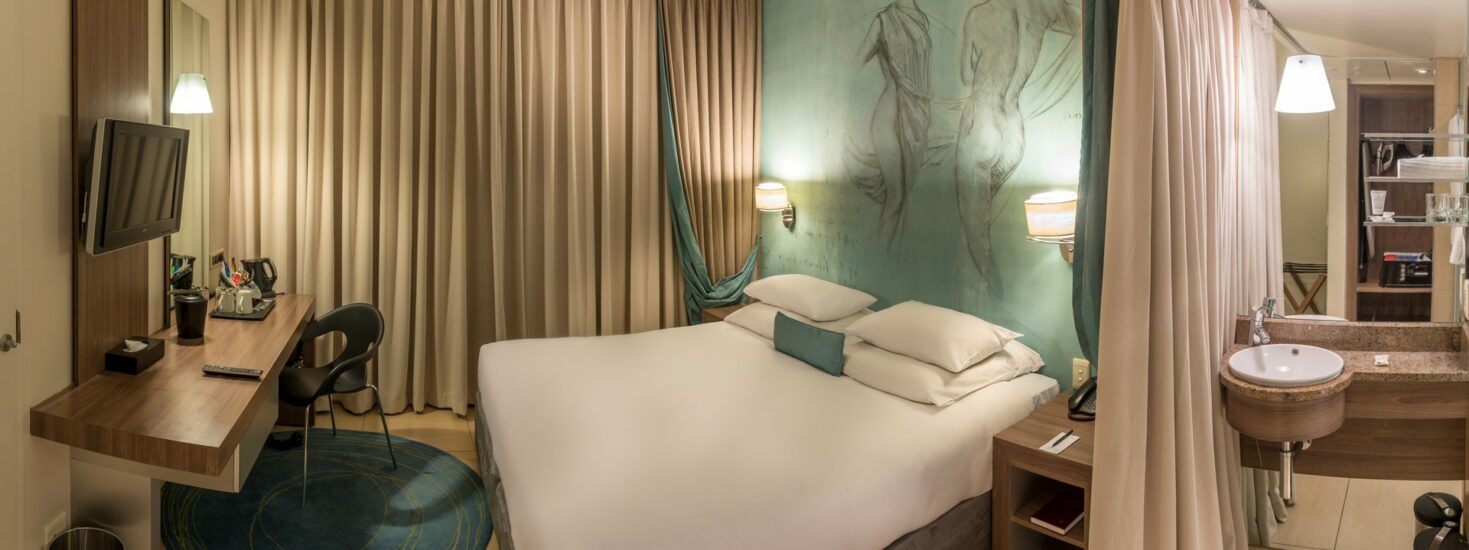 Panoramic view of a Classic King Room showing the work desk and vanity at Metcourt, Emperors Palace