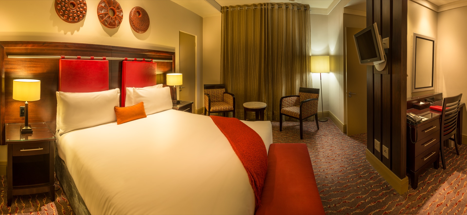 Presidential Suite bedroom and seating area at Peermont Mondior, a 4-star hotel near OR Tambo airport